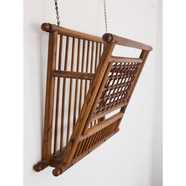 A rare and beautifully conceived English Victorian hanging magazine rack in oak, featuring an elaborately constructed...