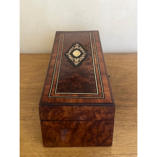 19th century French Thuya wood inlaid box covered with a burl veneer and decorated with a brass and mother of pearl emblem.