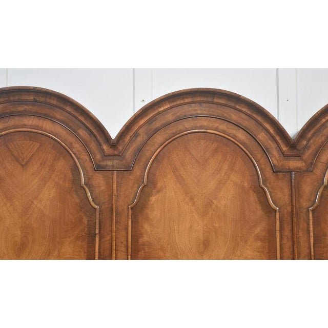 A well-proportioned Queen Anne–style triple wardrobe, crafted in richly figured walnut with attractive bookmatched veneers...