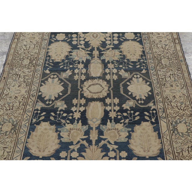 Hand-knotted in wool, this 4x6 antique Persian Malayer rug represents a sophisticated balance of tribal geometry and...