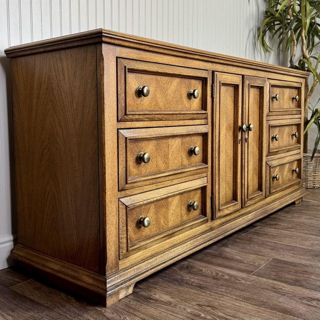Vintage Mediterranean-style triple dresser with parquet herringbone drawer fronts and brass hardware. This nine-drawer...