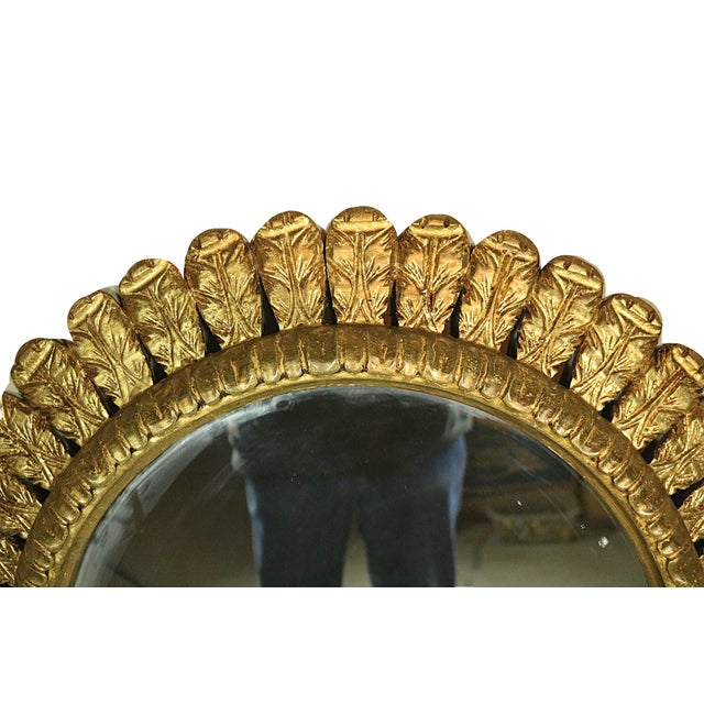 A large Spanish mid 20th century wall mirror with a gilded, carved wooden frame with the Prince of Wales feather design....