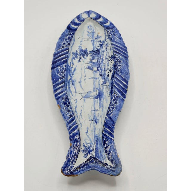A rare early antique Dutch Delft herring fish (haring-schaaltje) dish. It is early 19th-Century, hand painted in the...
