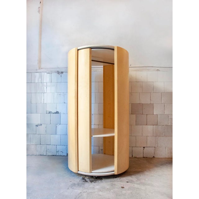 Cylindrical cabinet in lacquered wood and plastic. Accessible from two parts. Designer Gilberto Peguri Producer Peguri...