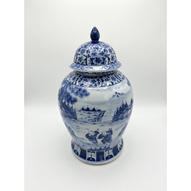 A beautifully hand-painted Chinese porcelain lidded ginger jar, showcasing a classic cobalt blue and white palette. This...