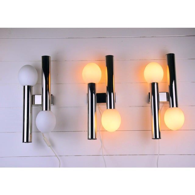 Very rare and stunning chrome wall lamp, created by the well known atelier Sciolari, is inspired by the Space Age...