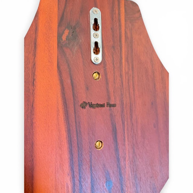 A striking Vagabond House pewter stag head wall mount, mounted on a rich wood plaque and framed by sculptural oak leaves...