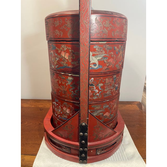This is an antique 19th century Chinese wooden red lacquered four-tier stacking wedding basket/box. It is a traditional...