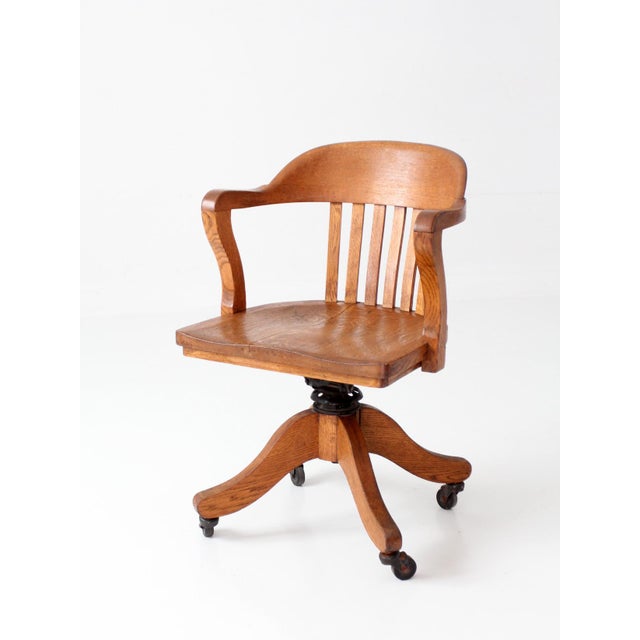 Antique W.H. Gunlocke oak banker’s chair dating to the early 20th century, exemplifying the exceptional craftsmanship and...
