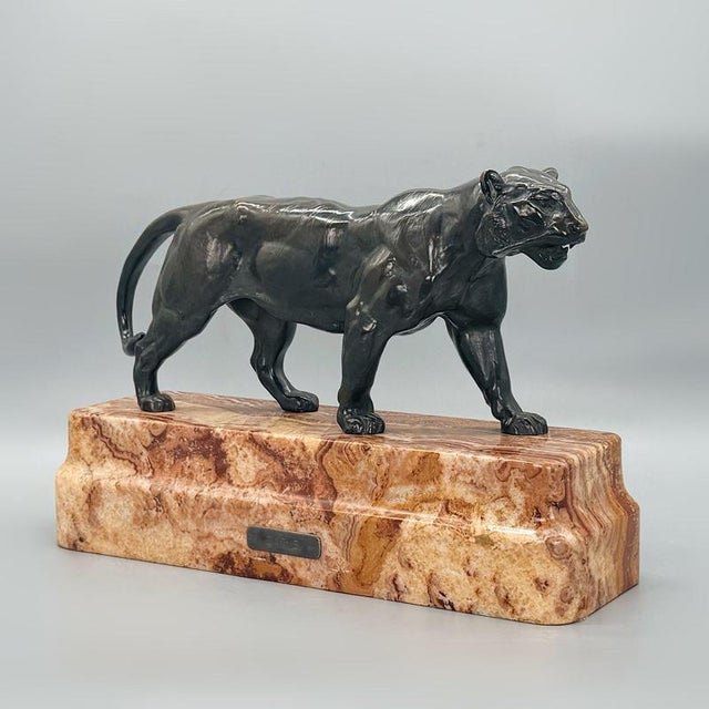 An early 20th century bronze sculpture cast after the original ' Tigre qui Marche' by Antoine Louis Barye. Set over a...