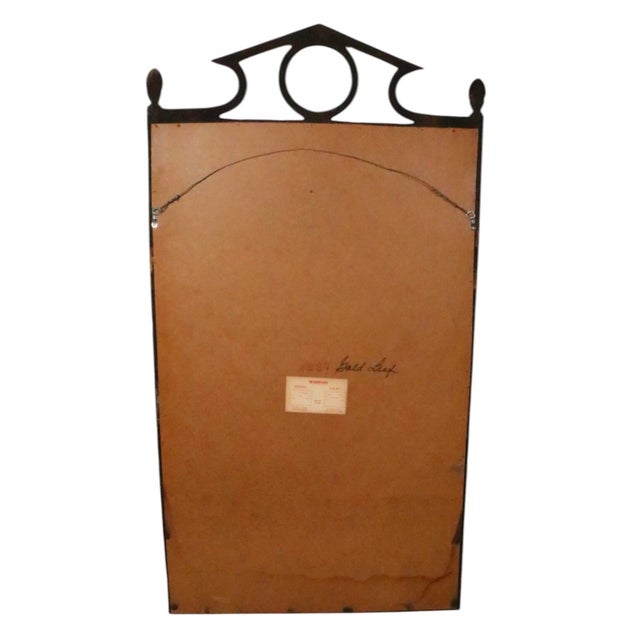 Chic faux gilt bamboo hanging mirror, showing Hollywood Regency, Campaign, Coastal style influences. This example is in...