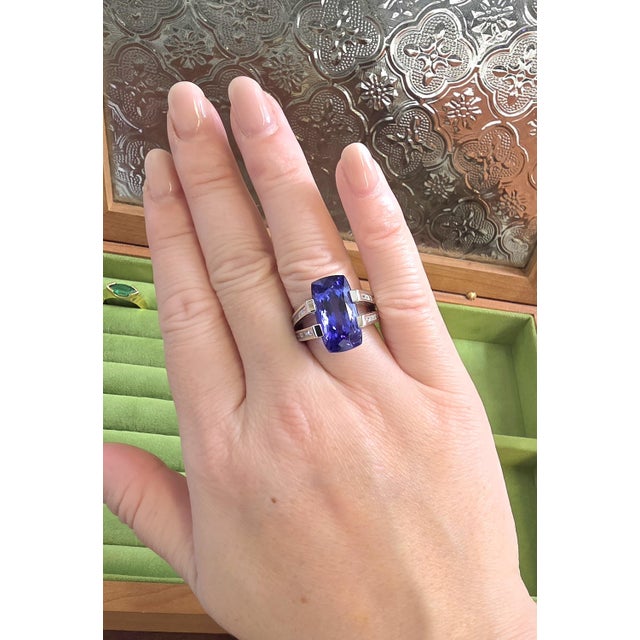 Estate 18K White Gold Tanzanite & Diamond Ring This striking estate ring is crafted in 18K white gold and showcases a...