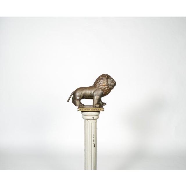 Expressive Mexican modernist lion sculpture crafted in patinated metal and mounted on a square base with decorative stud...