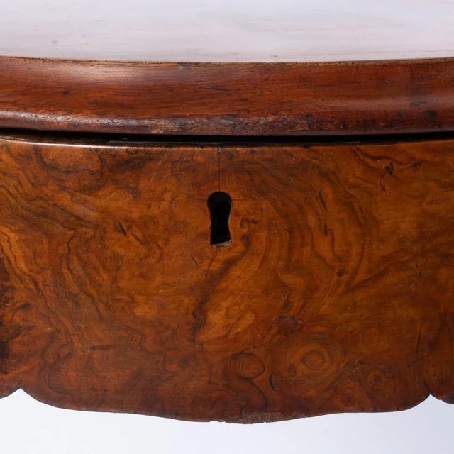 19th century English burr walnut Sewing table was made circa 1870. It features a top that lifts to reveal a fitted...