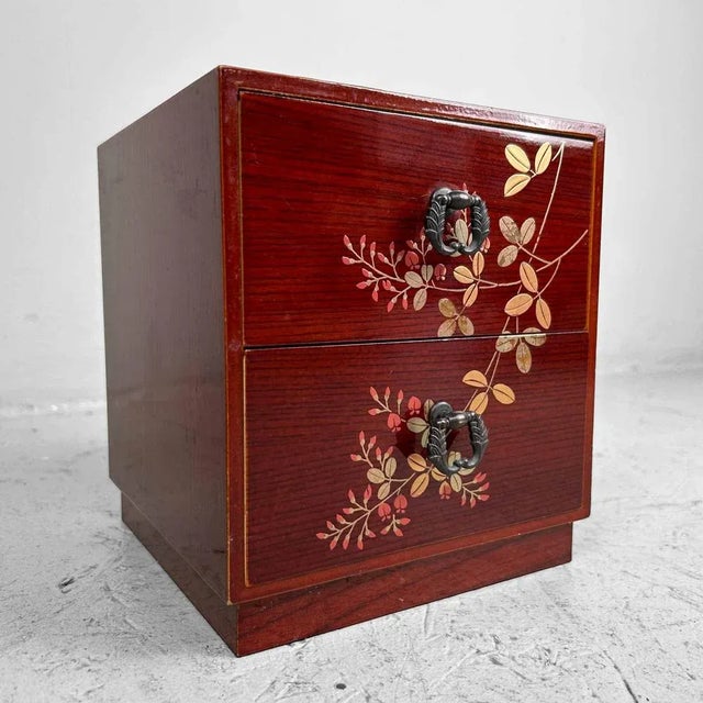 Beautiful lacquered cabinet with two drawers decorated with a floral motif from the 1970s-80s. Originally, these pieces of...