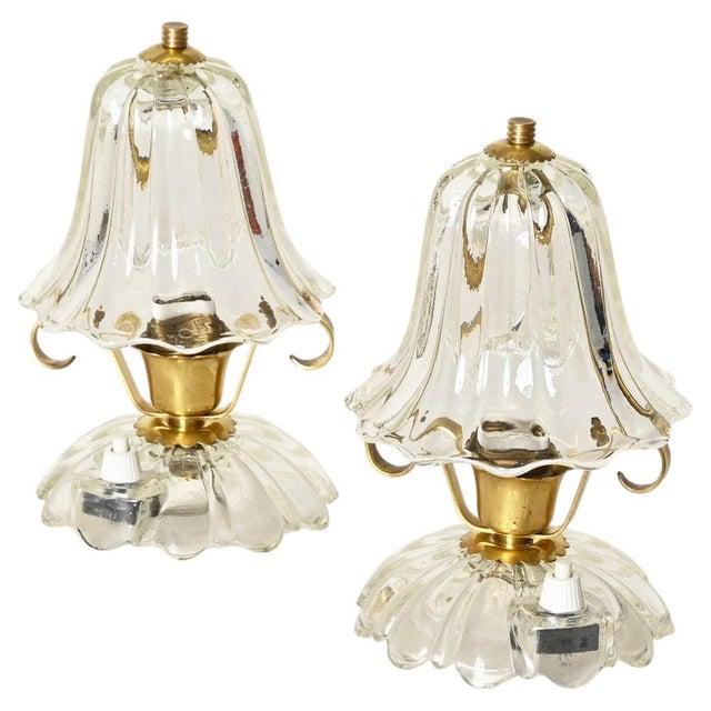 Stunning and rare pair of bell-flower-shaped table lamps in murano blown glass and brass. This incredibly elegant and...