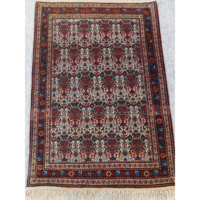 This intricately patterned antique Zilli Sultan Persian rug measures 3'6"x 5". Allover repeated vases, totalling 20, with...