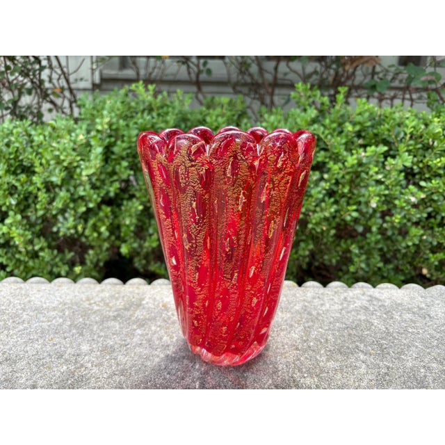 Murano Glass Vase. Offered is a beautiful hand blown Murano glass vase in a red ribbed design with gold flecks throughout....