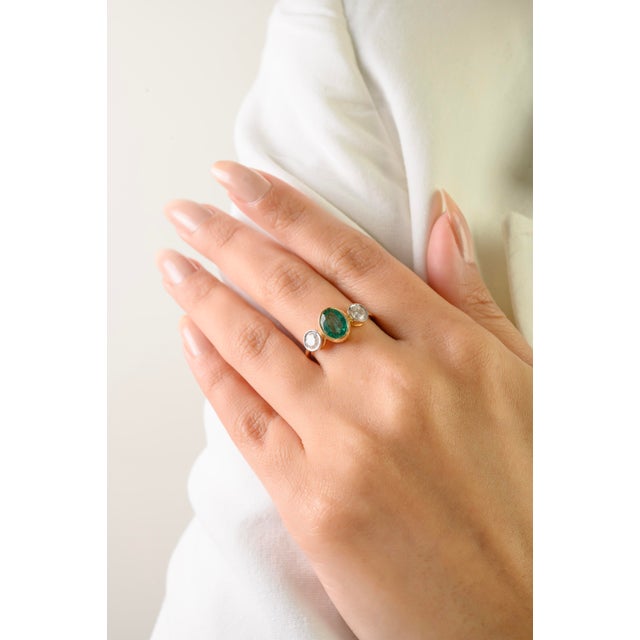 This elegant three-stone ring features 1 oval cut natural zambian emerald totaling 1 carat, set in rich 18k yellow gold....