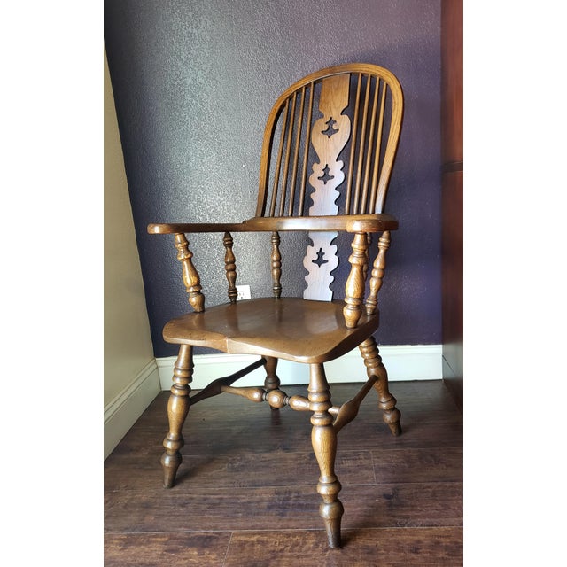A Mid-20th Century Conant Ball Arm Chair with a tall bentwood hoop back, with spindle supports and central pierced central...