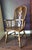 A Mid-20th Century Conant Ball Arm Chair with a tall bentwood hoop back, with spindle supports and central pierced central...