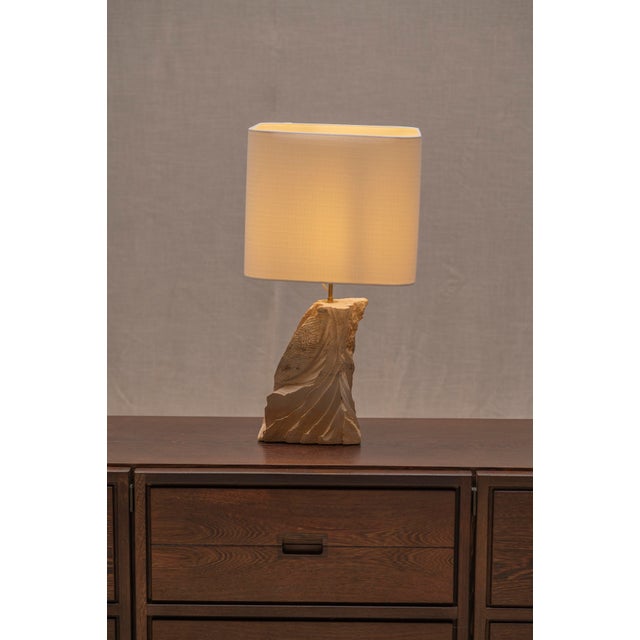 Distinctive French table lamp from the 1970s, crafted from solid natural sandstone. The sculptural base features an...