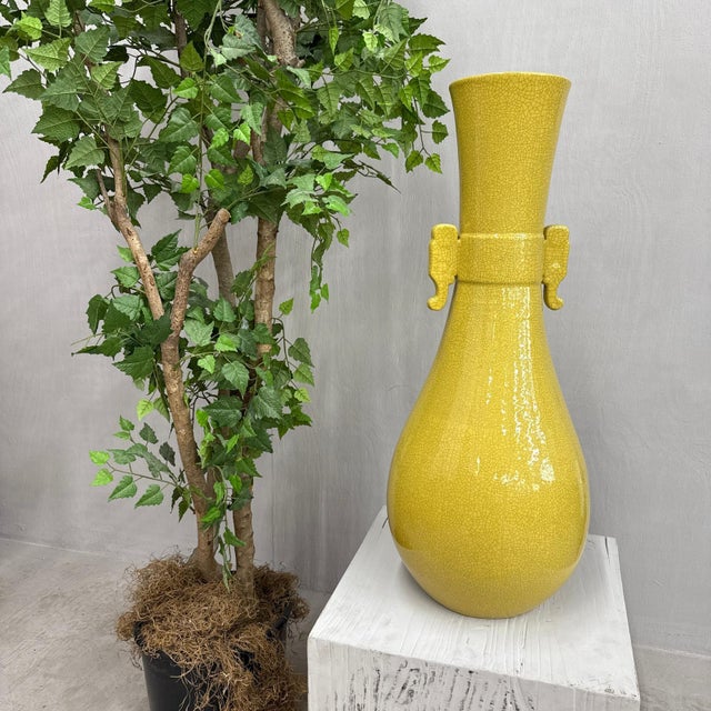 "About This Piece About This Piece Glowing in a radiant shade of golden yellow, this tall crackle-glazed vase captures the...