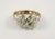 This is part of Chairish’s Costume Jewelry assortment. Crystal, rhinestone, and white beads and stones on a goldtone clamp...