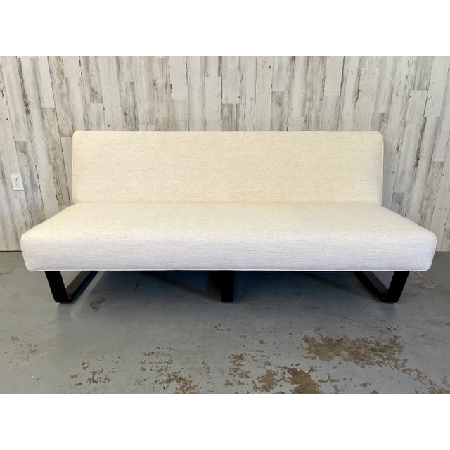 Edward Wormley slipper sofa for Dunbar with off white upholstery and ebonized bentwood legs. Older restoration. Label is...