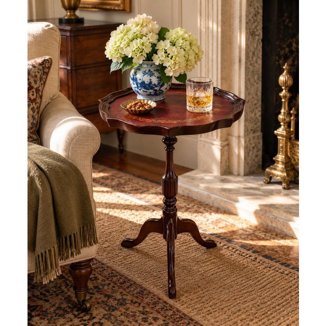 A handsome Georgian-style drinks table crafted in rich mahogany and finished with a beautifully embossed burgundy leather...