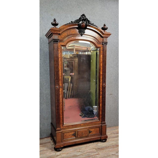 A Parisian Louis XVI style mirrored wardrobe in rosewood and elm burl, circa 1850, opening at the front with one beveled...