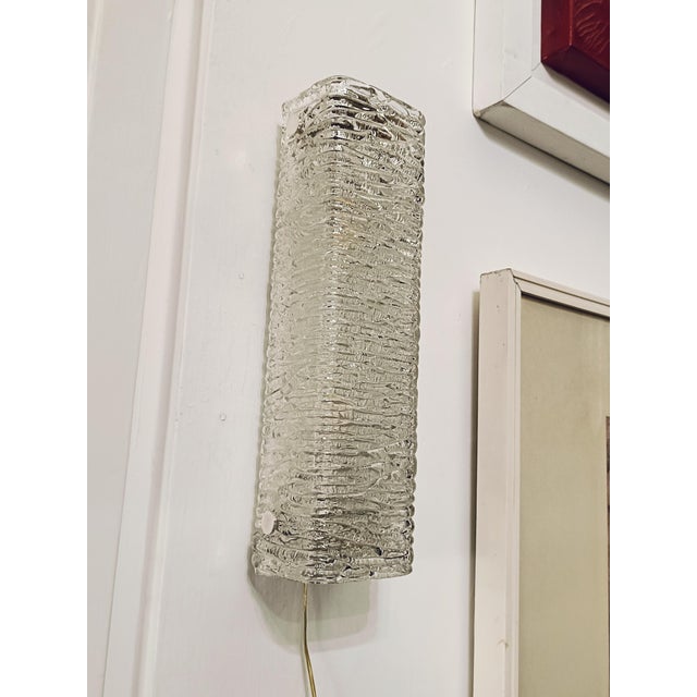 Beautiful glass wall light from the 1960s made by the high-end glass manufacturer Kaiser. The thick, structured glass...