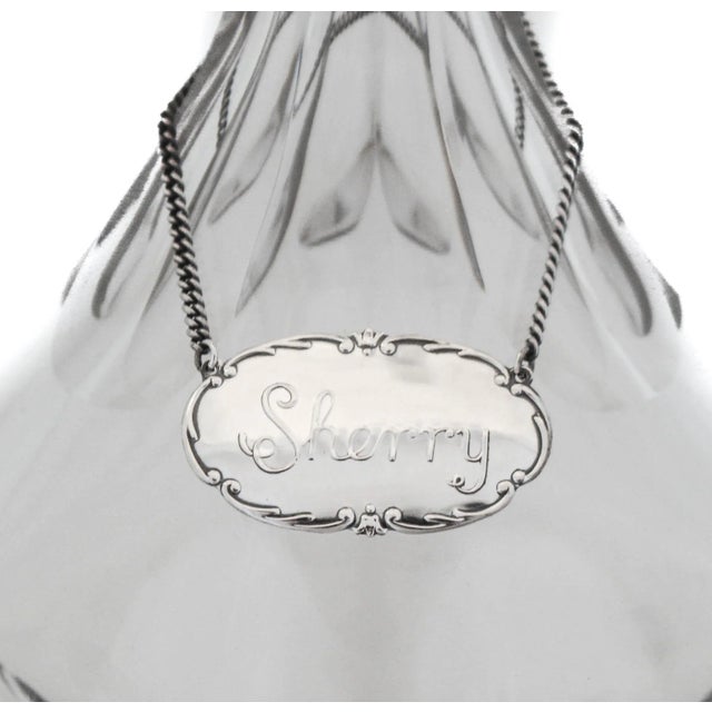 This liquor label is crafted of sterling silver, with the word "Sherry” engraved on the front. The perfect tag to put on...