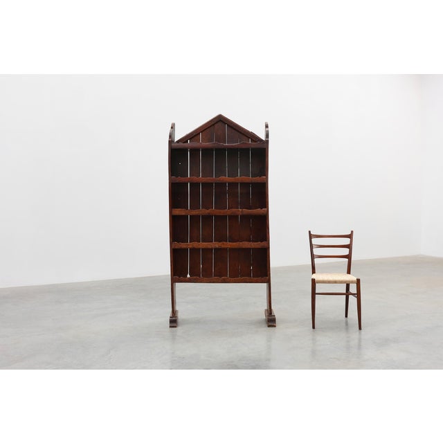 Evoking the rustic poetry of early rural craftsmanship, this solid chestnut shelving cabinet from France, circa 17th...