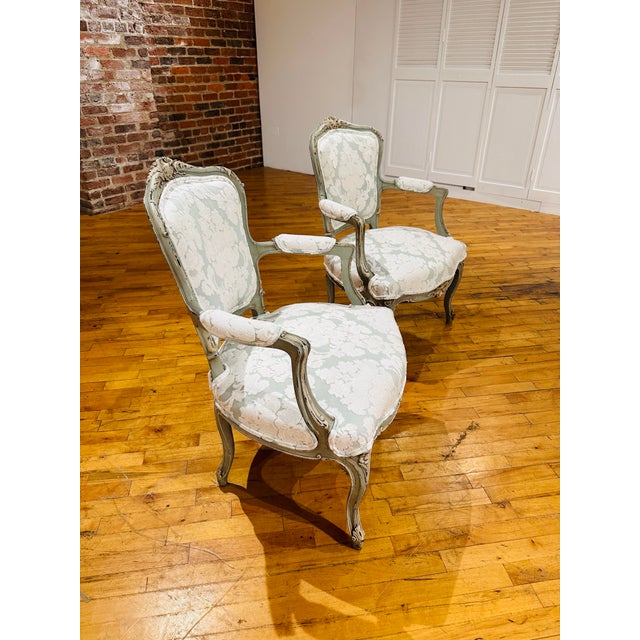 Stunning pair of French chairs. The wood frame is painted in original finish in a pale, beautiful blue with oyster white...