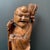 This happy Buddha statue with candle holder is intricately carved probably from a single piece of root wood and is likely...
