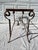 A single vintage rectangular iron console table base featuring scrolled legs and stretchers. Features a charming patina...