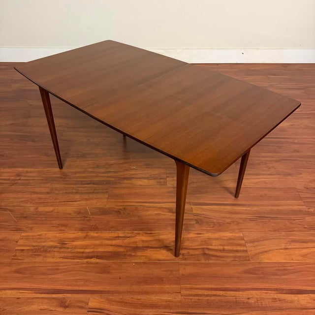Vintage teak butterfly leaf dining table, made in Scotland by A.H. McIntosh circa 1960's. This table features subtly...
