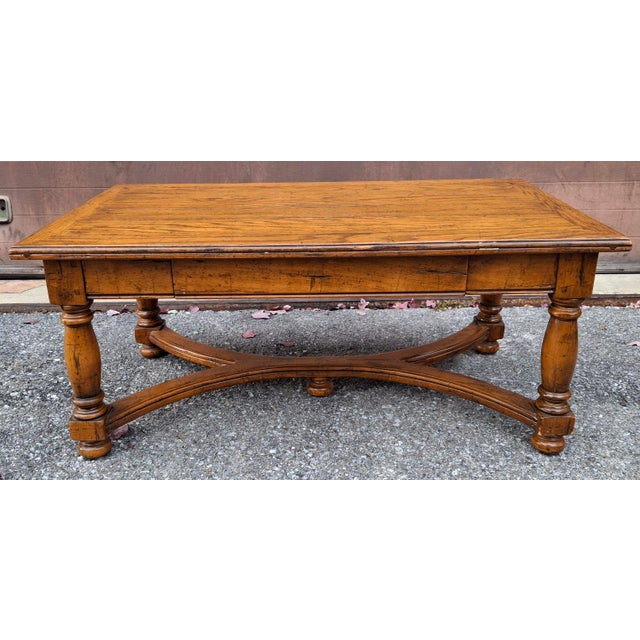 A late 20th Century Jacobean Style Oak Single Drawer Coffee Table with arch Stretcher. Measure 44" in width, 24" in depth...