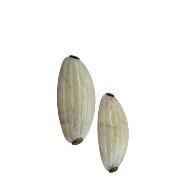A set of Italian wall lights from the 1980s, made of frosted glass with a subtle marble pattern and brass clamps at the...