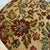 Cross stich food rest. Material is tan in color with a floral pattern. stool has 4 wooded legs that are a traditional...