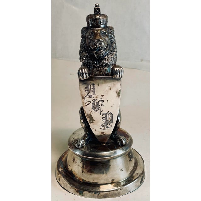 This is a fantastic fine quality silver plate inkwell in the form of a standing lion with a crown on his head and holding...