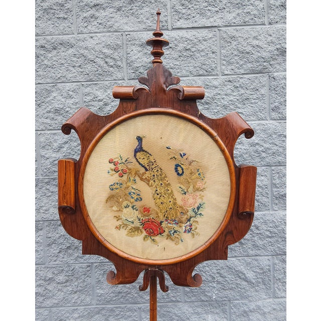 A 19th Century Victorian Renaissance style Rosewood with Floral And Peacock Needlepoint Pole Screen with exceptional...