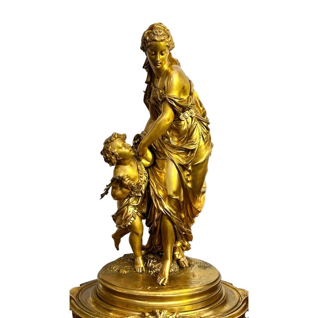 Antique (19th century) ormolu bronze mantel clock in the Louis XV/XVI style, finely modeled and cast, depicting Roman...