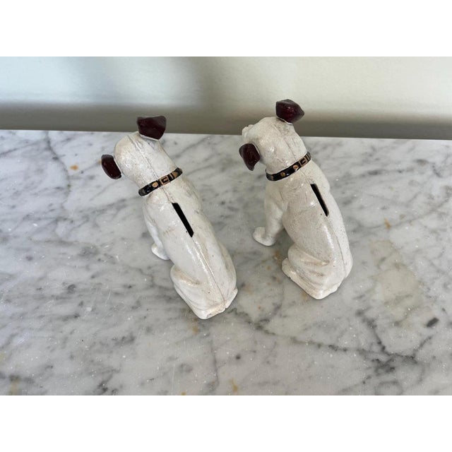 An endearing pair of vintage cast iron HMV ‘Nipper Dog’ children’s money boxes. Beautiful and endearing examples of...