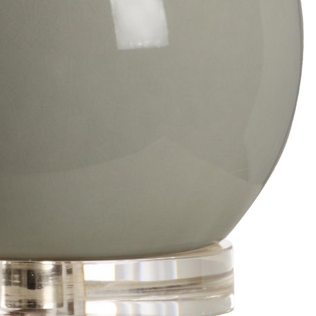 Provide accent lighting with this modern bottle style table lamp. A soothing sage green glazed ceramic with silver leaf...