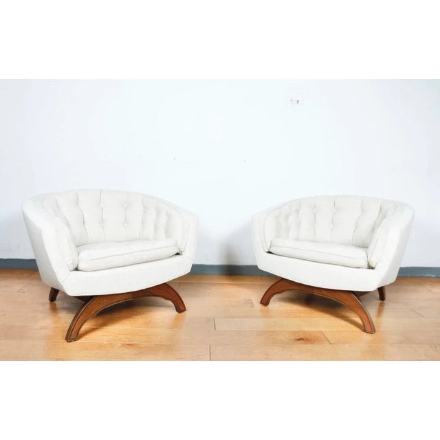 Gorgeous pair of tufted barrel chairs with sculpted walnut base. Great condition and super comfortable. Both have been...