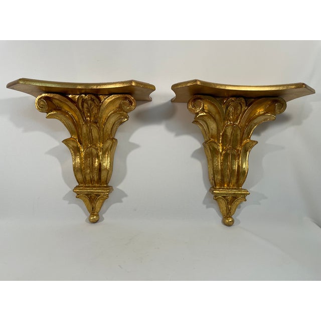 A gorgeous pair of carved Italian Giltwood Decorative Wall Shelf Brackets. Circa Mid 20th Century. "Made in Italy" stamped...