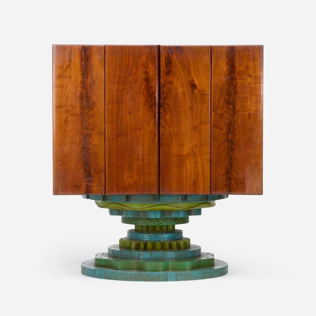 Phillip Lloyd Powell Rotating Walnut Case / Bar, 1965 Walnut, Carved and painted wood base, cane, felt interior...