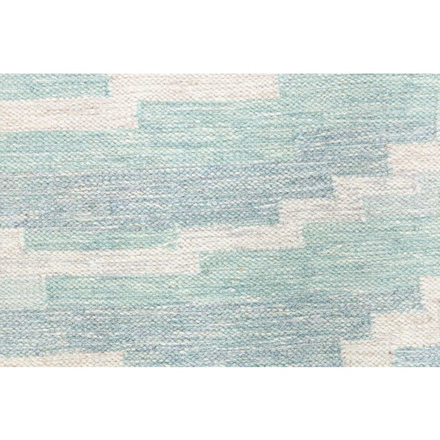 This vintage Swedish flat weave rug, designed by Agda Österberg in the mid-1950s, embodies the refined geometry and gentle...